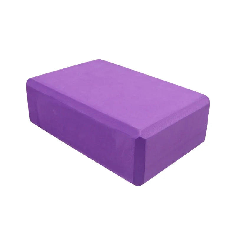 Purple yoga block on a white background