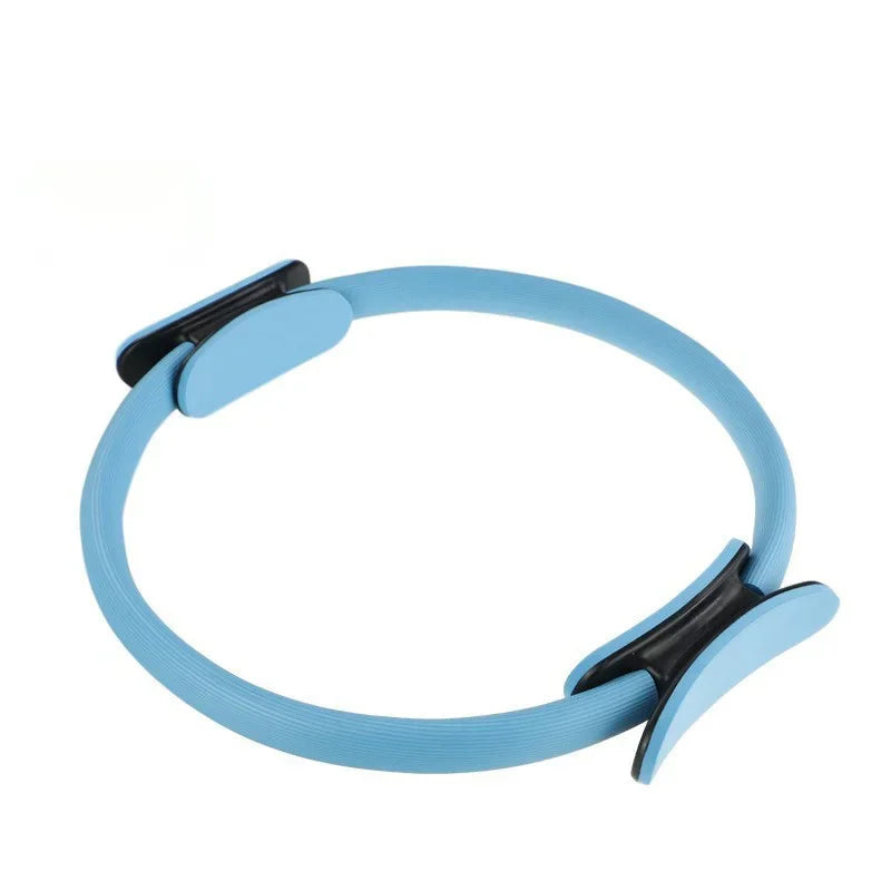 Blue Pilates ring with black handles on a white background