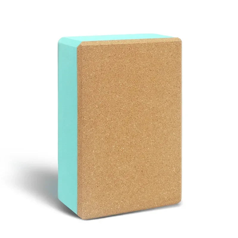 Yoga block with cork surface and turquoise side on a white background