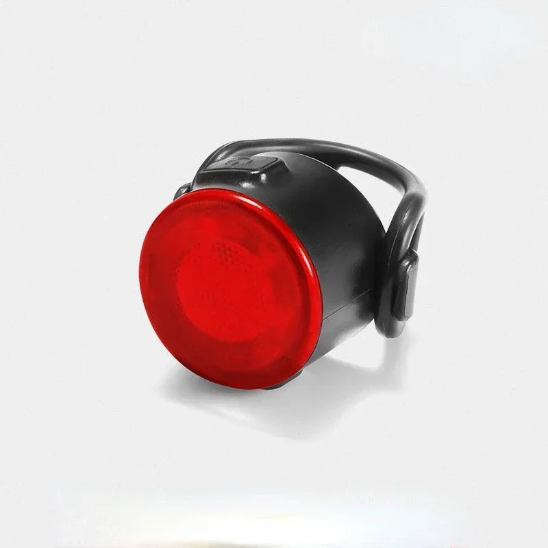 Red bike light with black casing on a white background