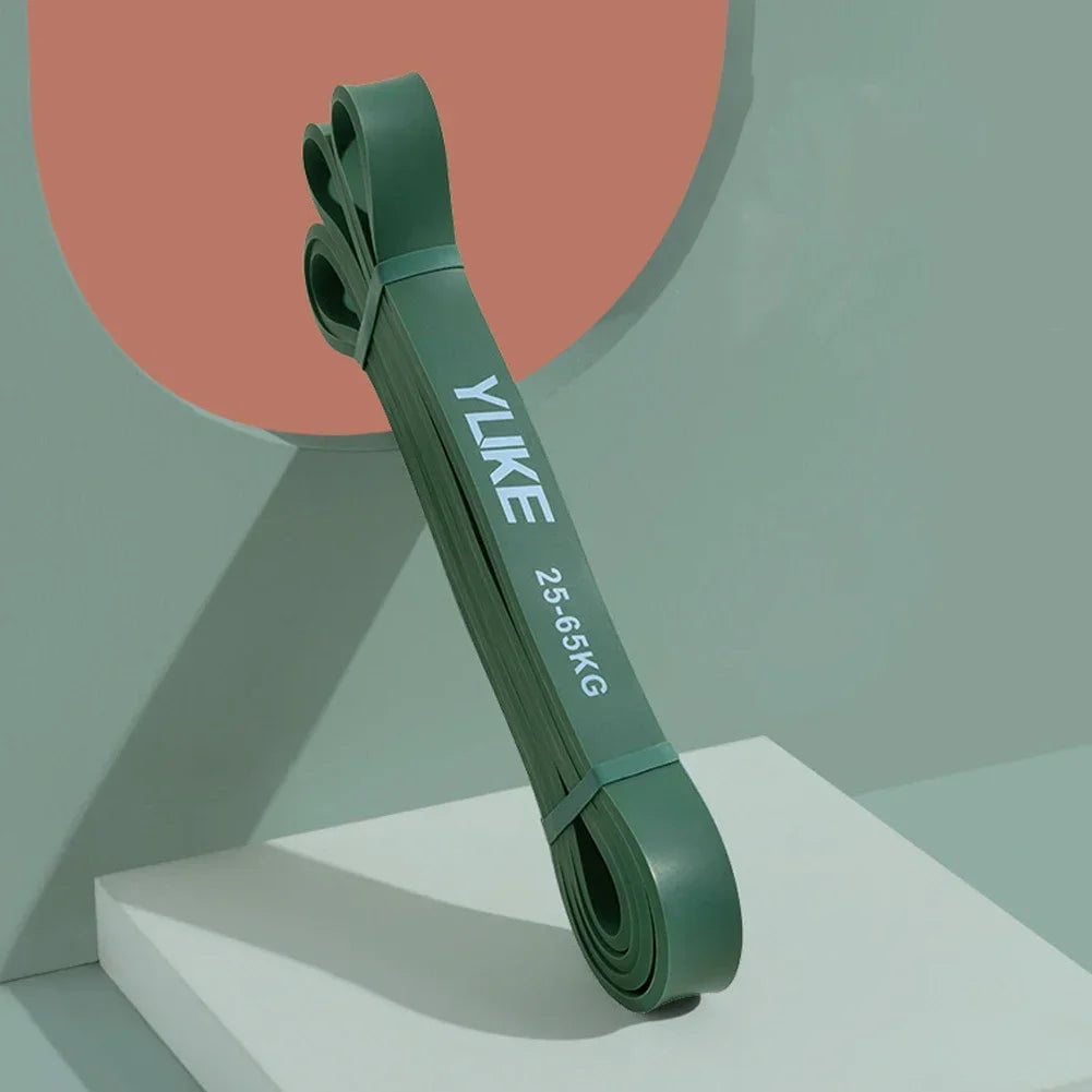 Green resistance band with 'YLIKE' branding on a geometric background