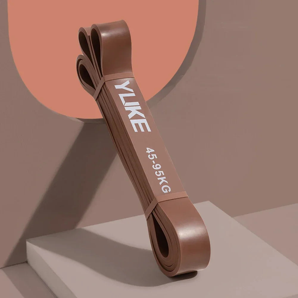 Brown resistance band with 'YUKE' branding on a neutral background