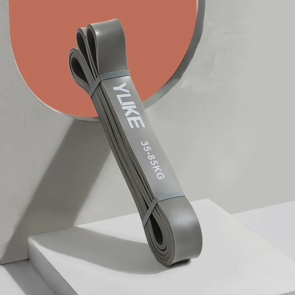 Gray resistance band with 'YUKE' branding on a neutral background