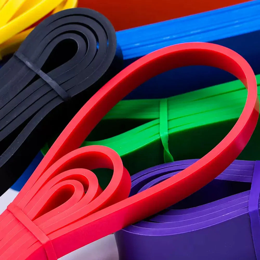 Colorful rubber bands in red, blue, green, and black on a white background