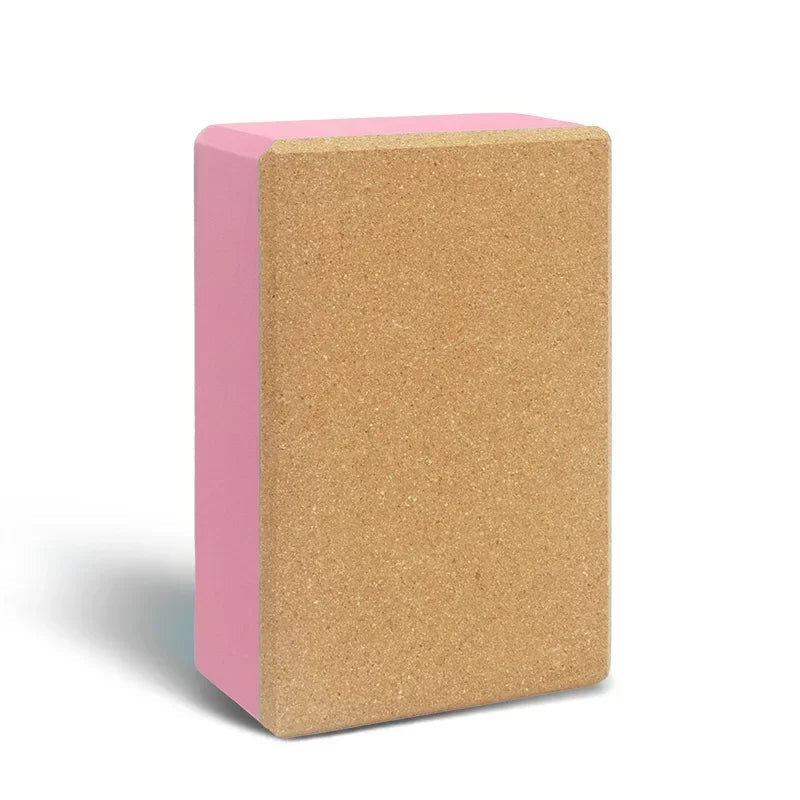 Yoga block with pink exterior and cork interior on a white background