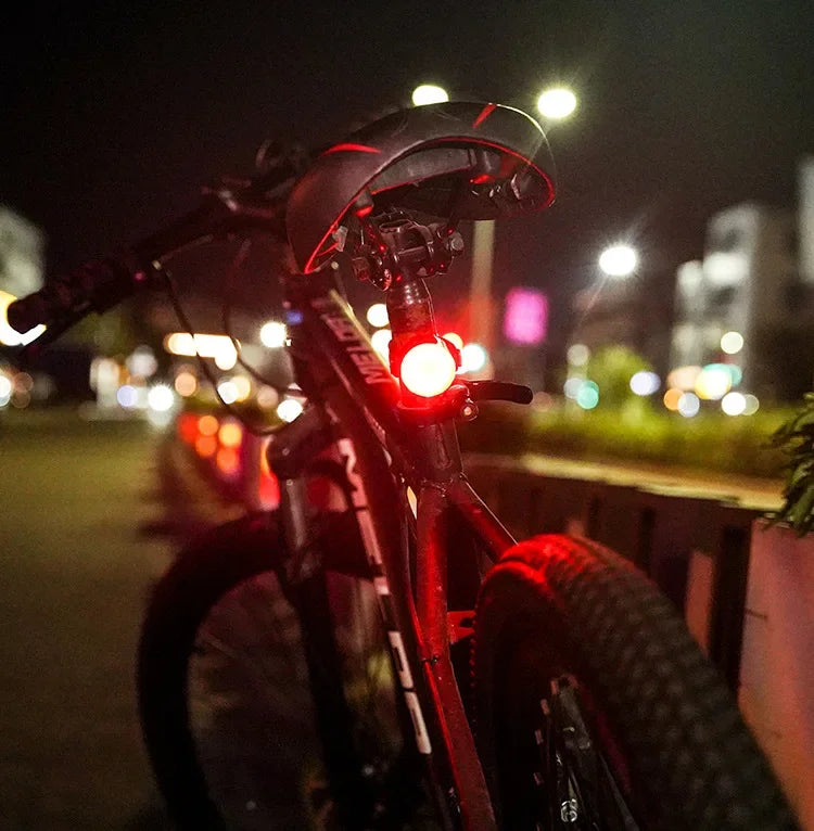 Bicycle with a red light on a blurred night-time city street