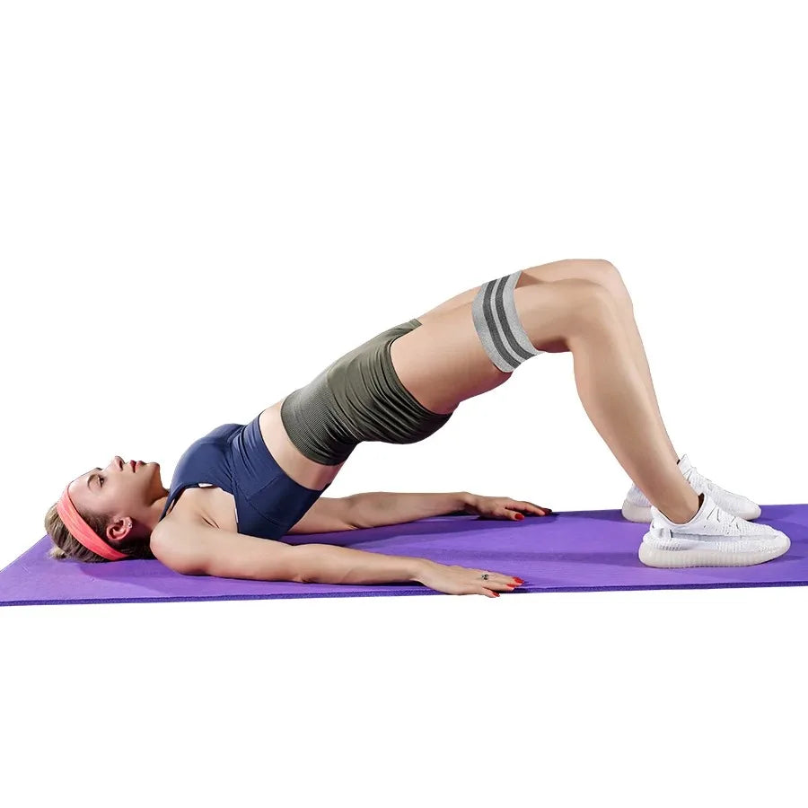 Person exercising on a purple mat with a white background
