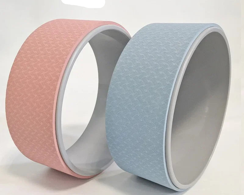 Two yoga wheels, one pink and one blue, on a light gray background with 'Yoga wheel' text.