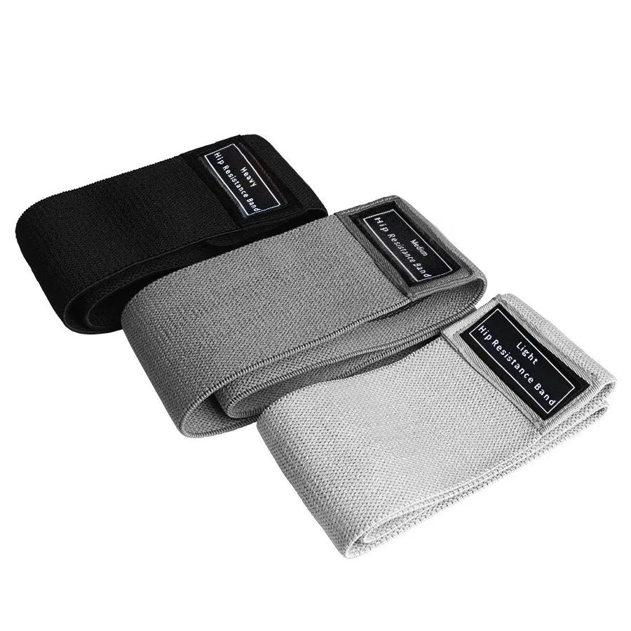 Three resistance bands in black, gray, and white on a white background