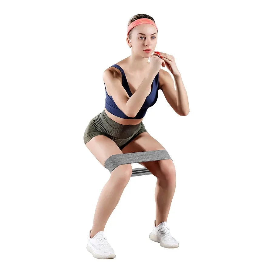 Woman exercising with resistance bands on a white background