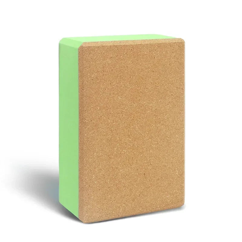 Yoga block with cork surface and green base on a white background