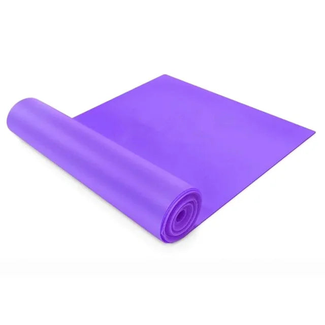 Purple yoga mat rolled up on a white background