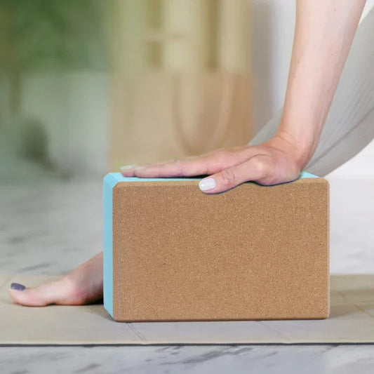 Person using a cork yoga block on a yoga mat
