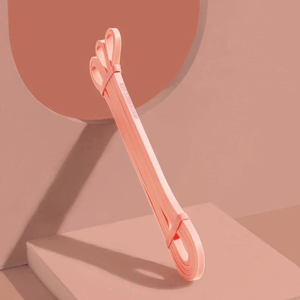 Pink belt with a clasp on a peach-colored background