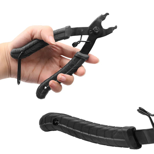 Hand holding a black tool with a non-slip handle on a white background