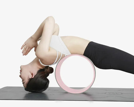 Person using a pink yoga wheel on a white background with text about pressure resistance.