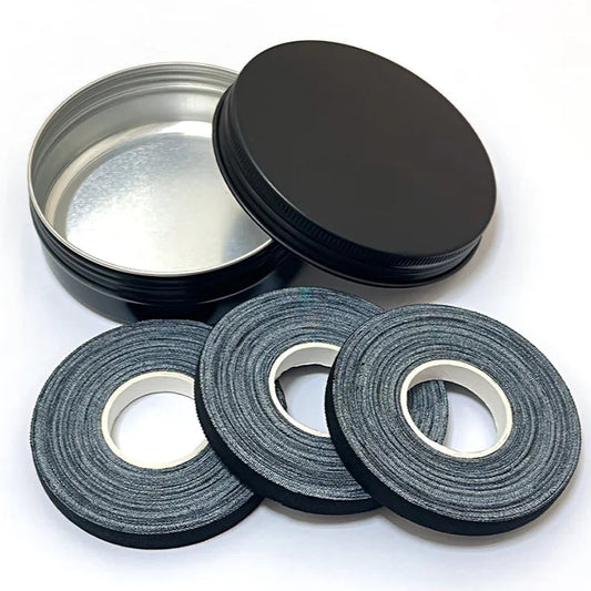 Three rolls of hypoallergenic tape with a container on a white background