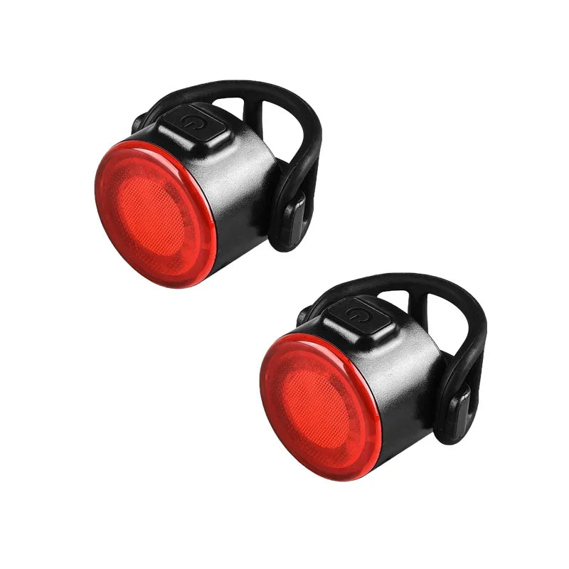 Two red bike lights with black casings on a white background