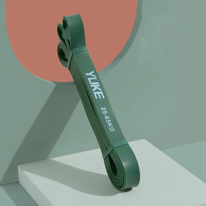 Green resistance band with 'YLIKE' branding on a geometric background