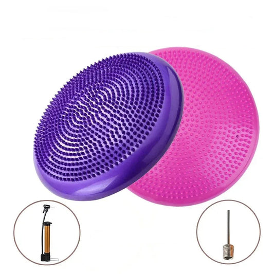 Purple and pink massage balancing yoga air cushions with pump and needle on a white background