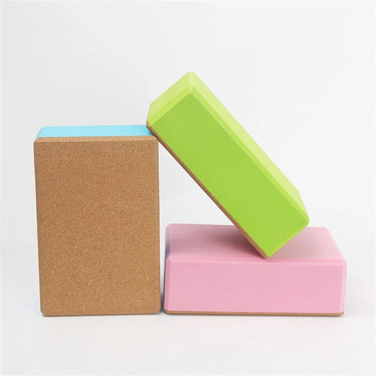 Three colorful yoga blocks stacked on a white background