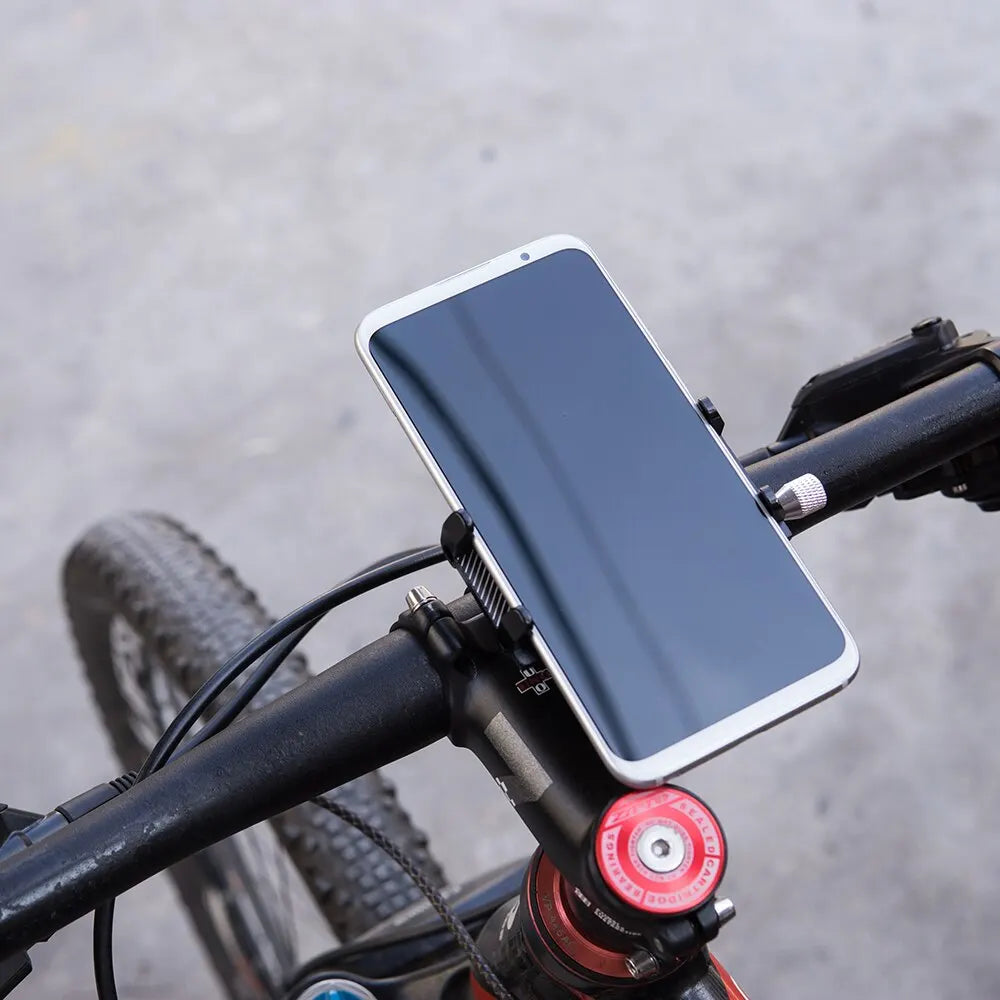 Smartphone mounted on a bicycle handlebar with a blurred road background