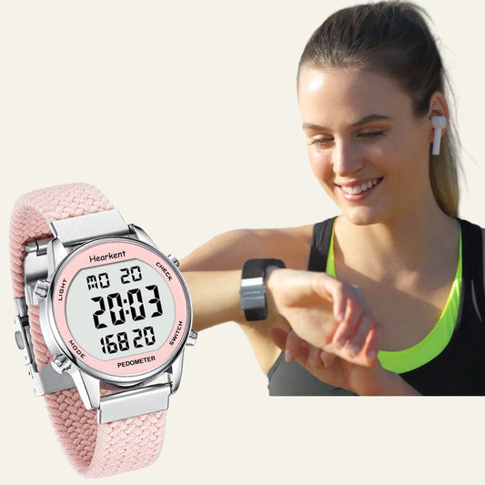 Woman wearing a pink pedometer watch with key features highlighted.