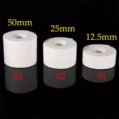 Three rolls of white tape with measurements labeled on a black background