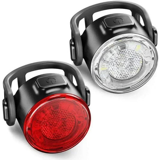 Black bicycle lights with red front light and clear back light on a white background
