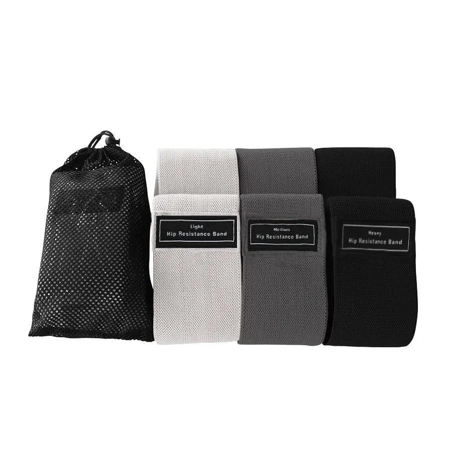Four resistance bands in black, white, gray, and black with a mesh storage bag on a white background.