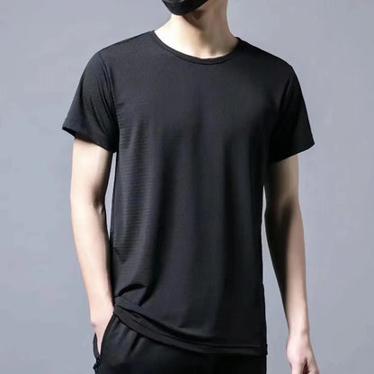 Person wearing a black t-shirt against a gray background
